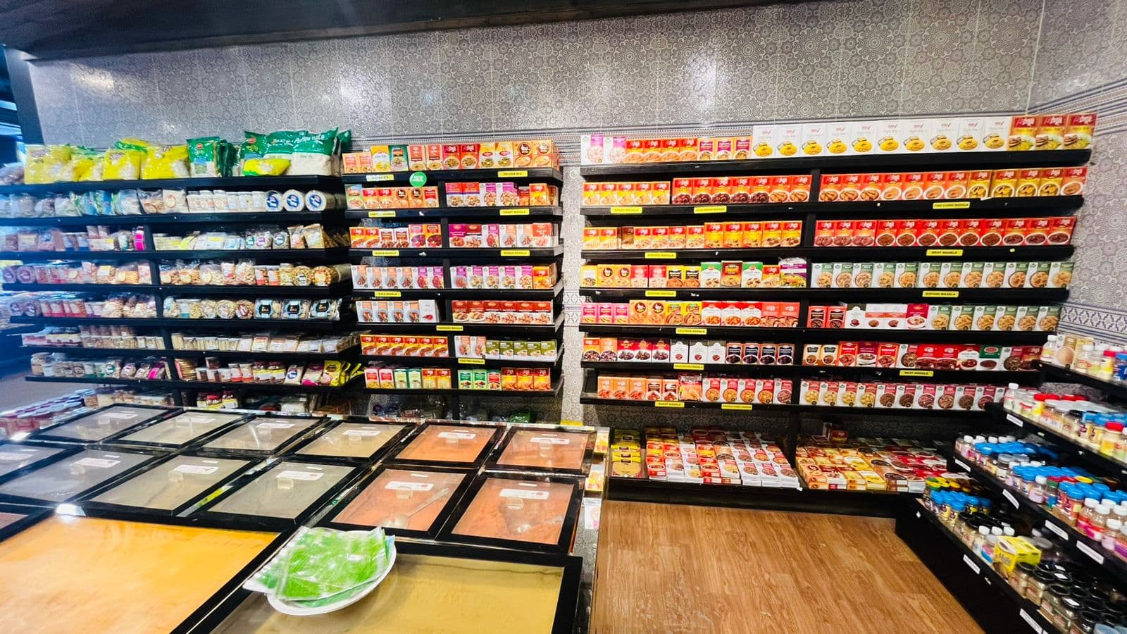 Shelves of spices, masala and dry goods at Khulshi Mart