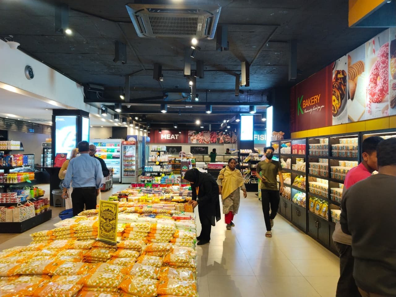 Customers shopping in the Khulshi Mart aisles